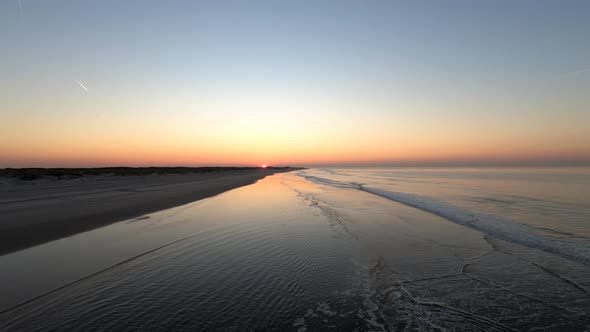 Aerial view low over the beach, towards sunset, on Langeoog island alt