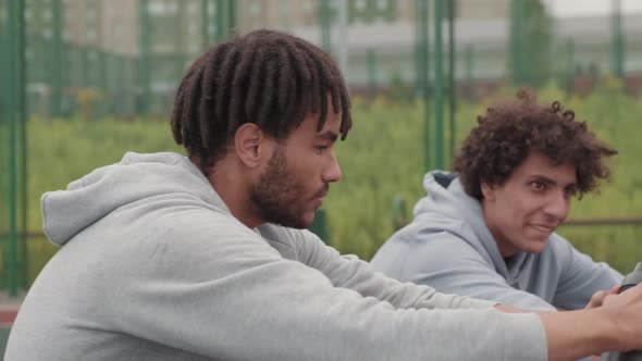Happy Guys Resting after Basketball Game Outdoors alt