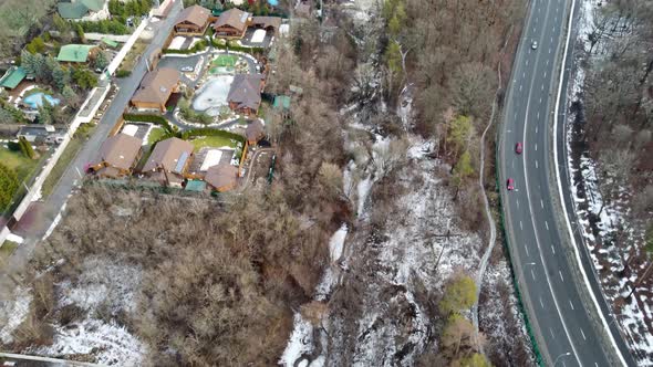 Fly above city street, residential area in winter