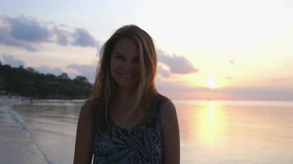 Beautiful Happy Woman Enjoying Peaceful Seaside at Sunset