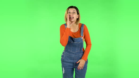 Girl Looks Around, Covers Her Mouth with Her Hand and Whispers the Secret and Making a Hush Gesture alt