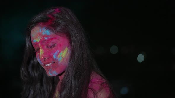 Dancing Young Indian Woman with Dry Color Powder Holi Exploding Around Her