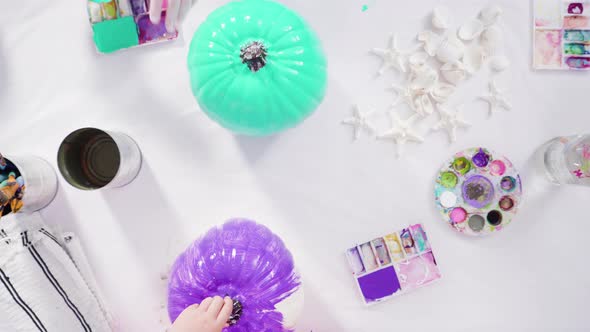 Flat lay. Step by step. Painting craft pumpkin with acrylic paint to create decorated mermaid Hallow alt