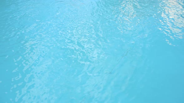 Water Surface Texture Slow Motion Clean Swimming Pool Ripples and Wave Refraction of Sunlight Top