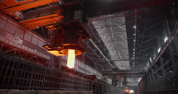The Crane Gives Out a Mold of Molten Steel and Puts It on a Trolley for Transportation alt