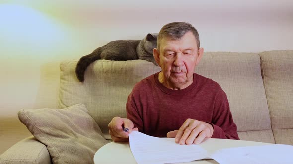 Elderly Man Signs Business Documents