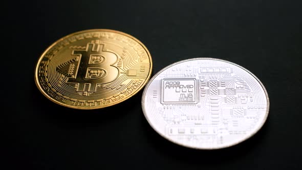 Golden and Silver Bitcoin Coins on Black