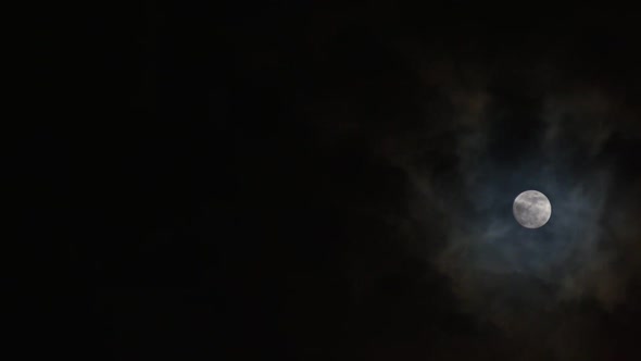Clouds passing by moon at night. Full moon at night with cloud real time. mystery fairyland scene. alt