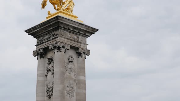 Alexandre III bridge golden statues column detail in Paris France slow tilt 4K 2160p UltraHD tilt fo alt