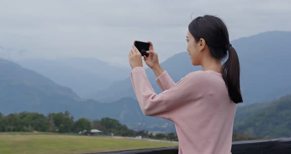 Woman Take Photo on Cellphone with Beautiful Scenery View alt