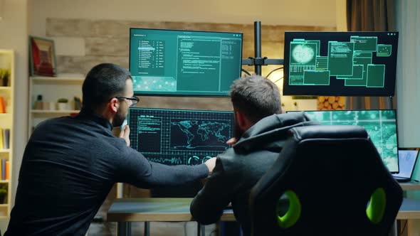 Team of Dangerous Male Hacker Using a Powerful Computer alt