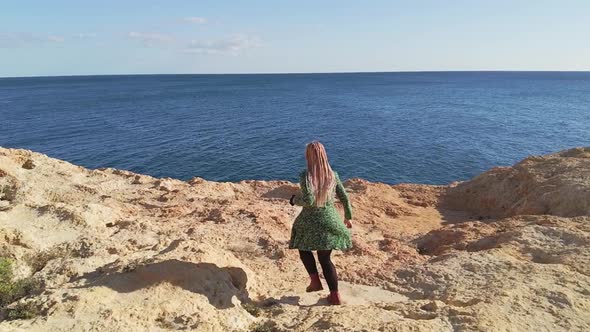 Blond Head Beautiful Woman Running Slowly on Rocky Hills alt