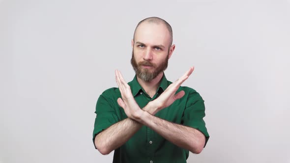 Man showing refusal gesture no. Serious bearded man is gesturing negatively.