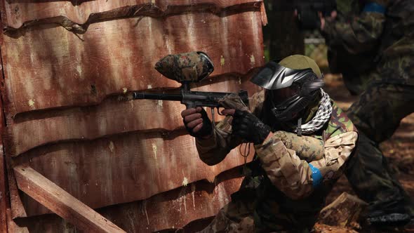 Paintball Sport Player Wearing Protective Mask Shooting alt
