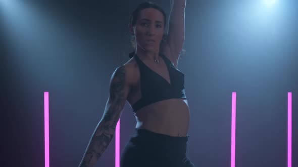 Graceful Female Dancing in Smoky Studio and Spotlight alt