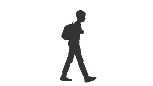 Silhouette of Walking Teenage Boy With Backpack