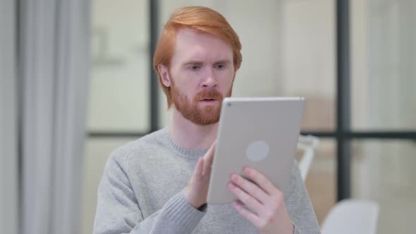 Successful Beard Redhead Man Celebrating on Tablet alt
