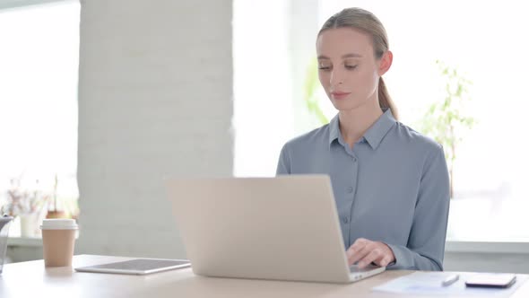 Busy Woman Using Laptop in Office alt