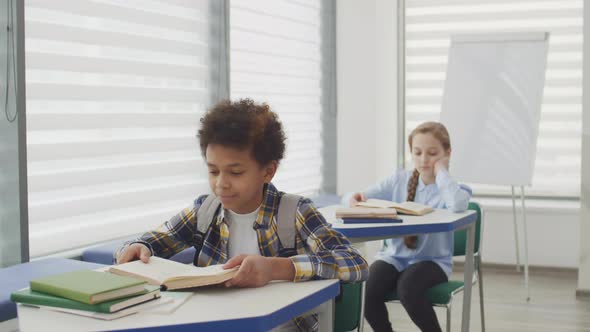 African Boy and Caucasian Girl in Classroom alt