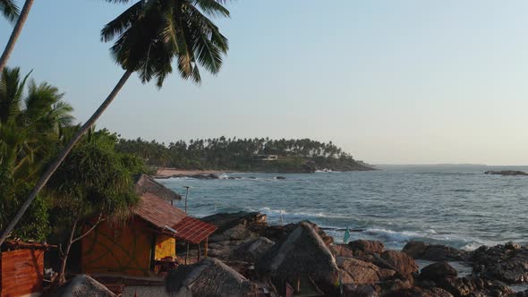 View of the Ocean, Palm Trees, Rocks and the Rising Sun. Sri Lanka Island