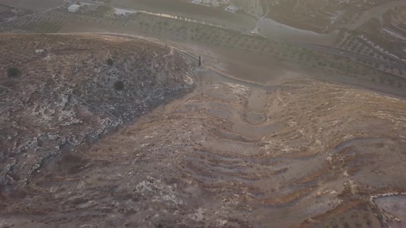 Aerial view of a barren hill going to the town of Arraba Palestine Middle East alt