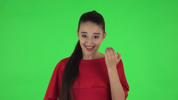 Portrait of Pretty Young Woman Is Waving Hand and Showing Gesture Come Here. Green Screen alt