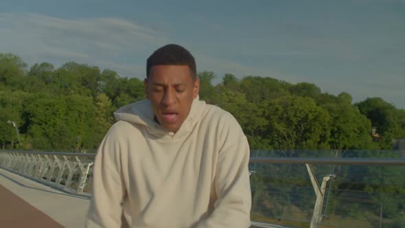 Exhausted Sporty African American Male Runner Taking Breath During Morning Jog alt