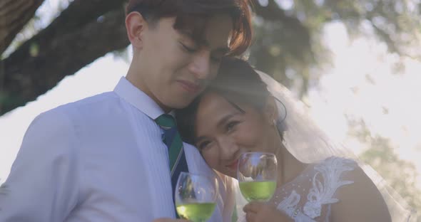 Slow motion Asian Bride And Groom Enjoying Champagne On Their Wedding Celebration. alt