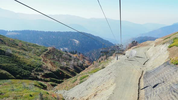 ROSA-KHUTOR, RUSSIA - October 13, 2018. Moving Cabins of the Cable Road. Funicular Moving Over Trees