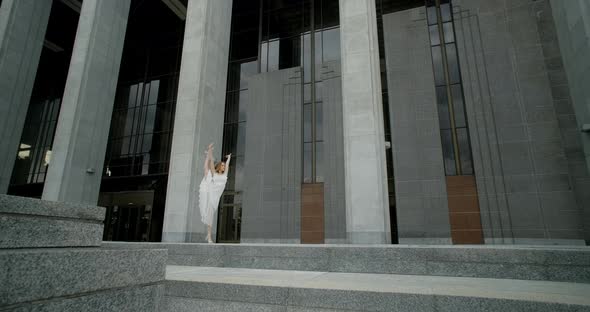 Young Dancer in White Dress Does Leg Swing in Slow Motion Outdoors Balerina Dances in the Gallery of alt