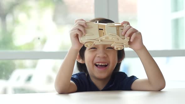 Cute Asian Child Playing Wood Model Cars Slow Motion  alt
