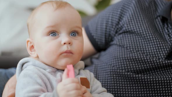 Young Baby Tasting Colourful Toy