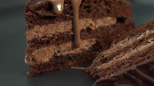 Chocolate Cream Flows on Freshly Baked Chocolate Cake with Nut Filling alt