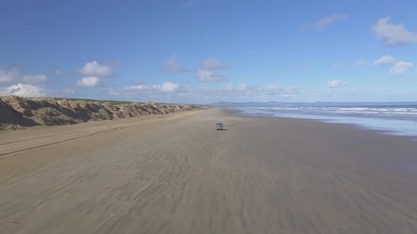 Aerial footage of driving car on the beach