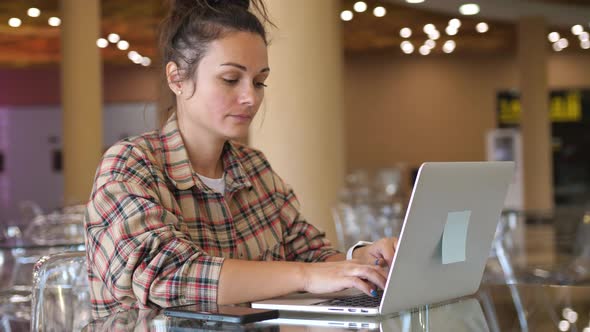Woman Working with Laptop on Desktop