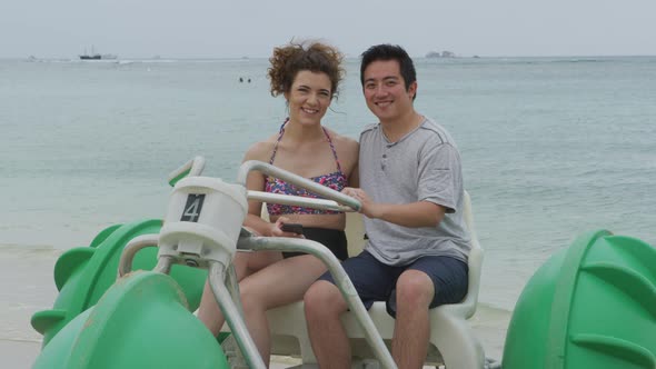 Portrait of couple on water tricycle in Hawaii