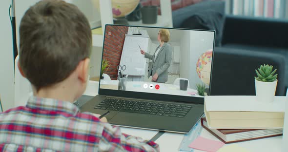 Teacher is Teaching Online Video Lesson on Laptop Computer for Smiling Little Boy at Home