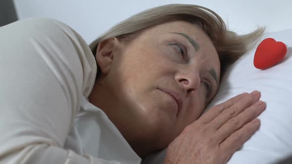 Sad Female Patient Holding Toy Heart in Hands, Hope Sign, Cardiological Problems alt