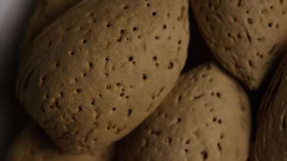 Cinematic, rotating shot of almonds on a white surface  alt