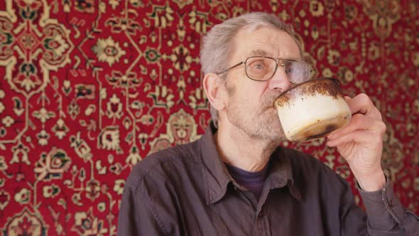 Senior Beggar Man Drinking Tea Alone alt