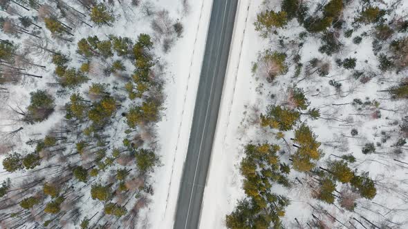 Riding a car on a winter road The drone view of winter driving Forest Winter Travel Kansk alt
