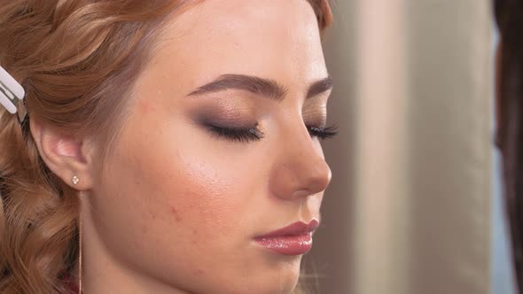Applying Makeup. Giving the Eyes of the Young Girl's Expression. Eyelash Extensions on the Eye. alt