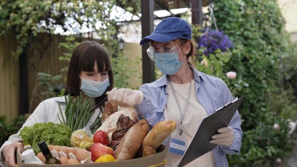 Food Delivery, Young Attractive Female Courier Wearing Medical Mask and Gloves To Protect Against alt