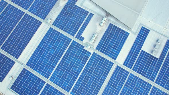 Aerial cinematic view of a solar panel on mall roof top alt