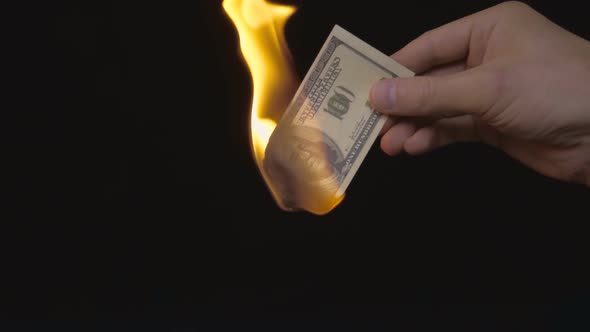 Incineration Of $ 100 Bills On A Black Background. Slow Mo 2