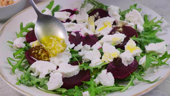 Beetroot and goat cheese salad with nuts and arugula alt