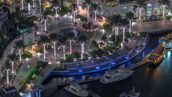 Dubai Marina Walk with Fountain and Palms Aerial Top View Night Timelapse alt