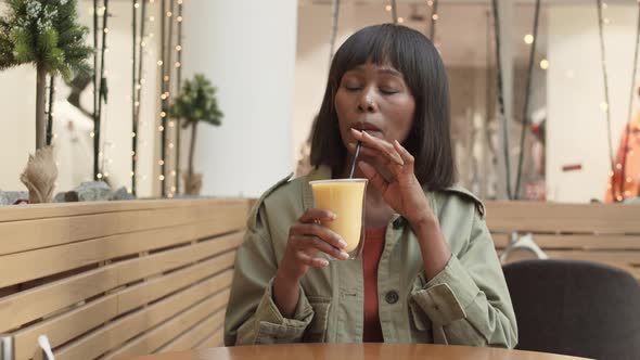 African Woman Drinking Milkshake alt