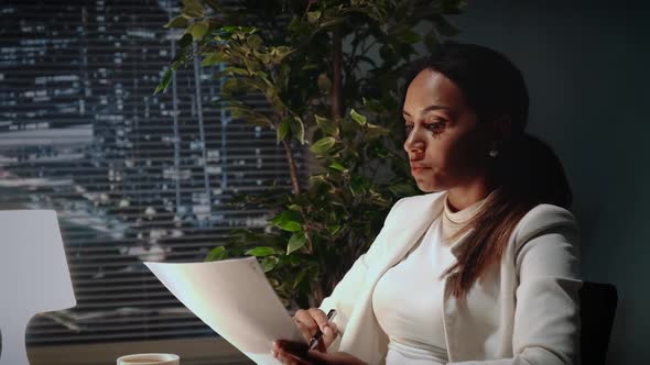 Beautiful African American Business Woman Explaining the Text of Contract in Office alt