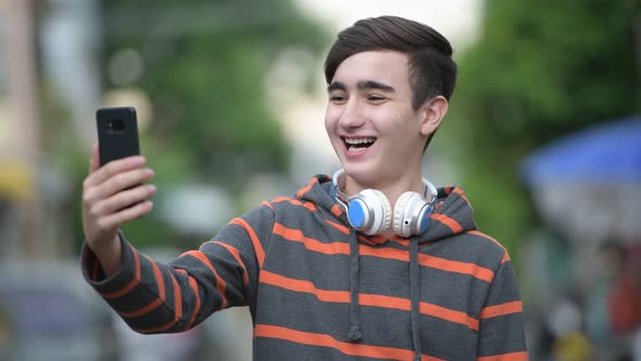 Young Handsome Iranian Teenage Boy in the Streets Outdoors alt
